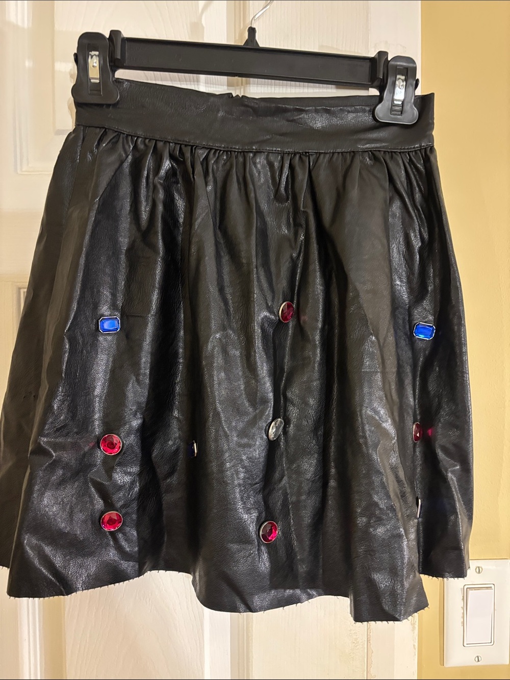Odi et Amo Black Faux Leather Mini Skirt with Red and Blue Gem Embellishments